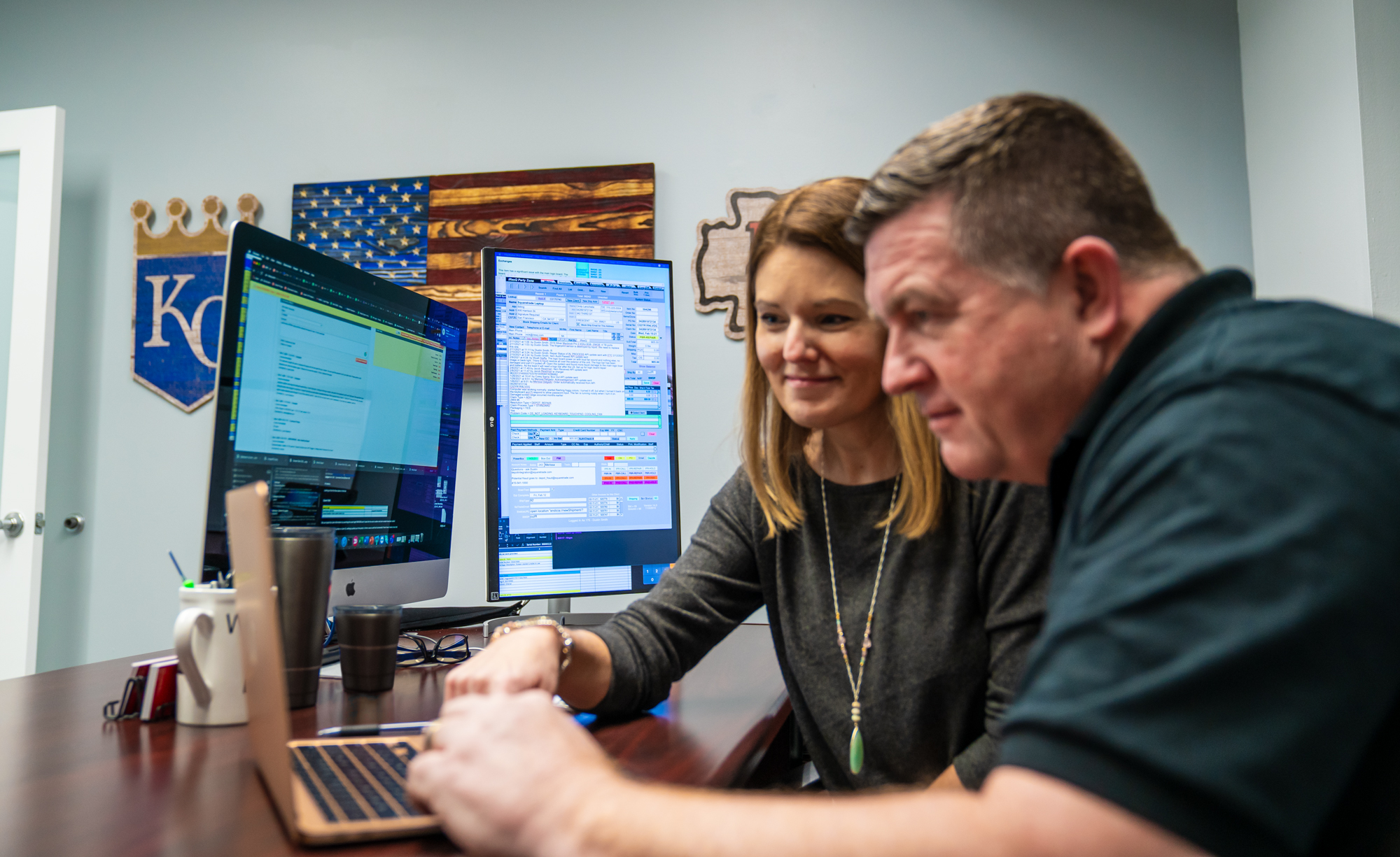 man and woman looking at computer together