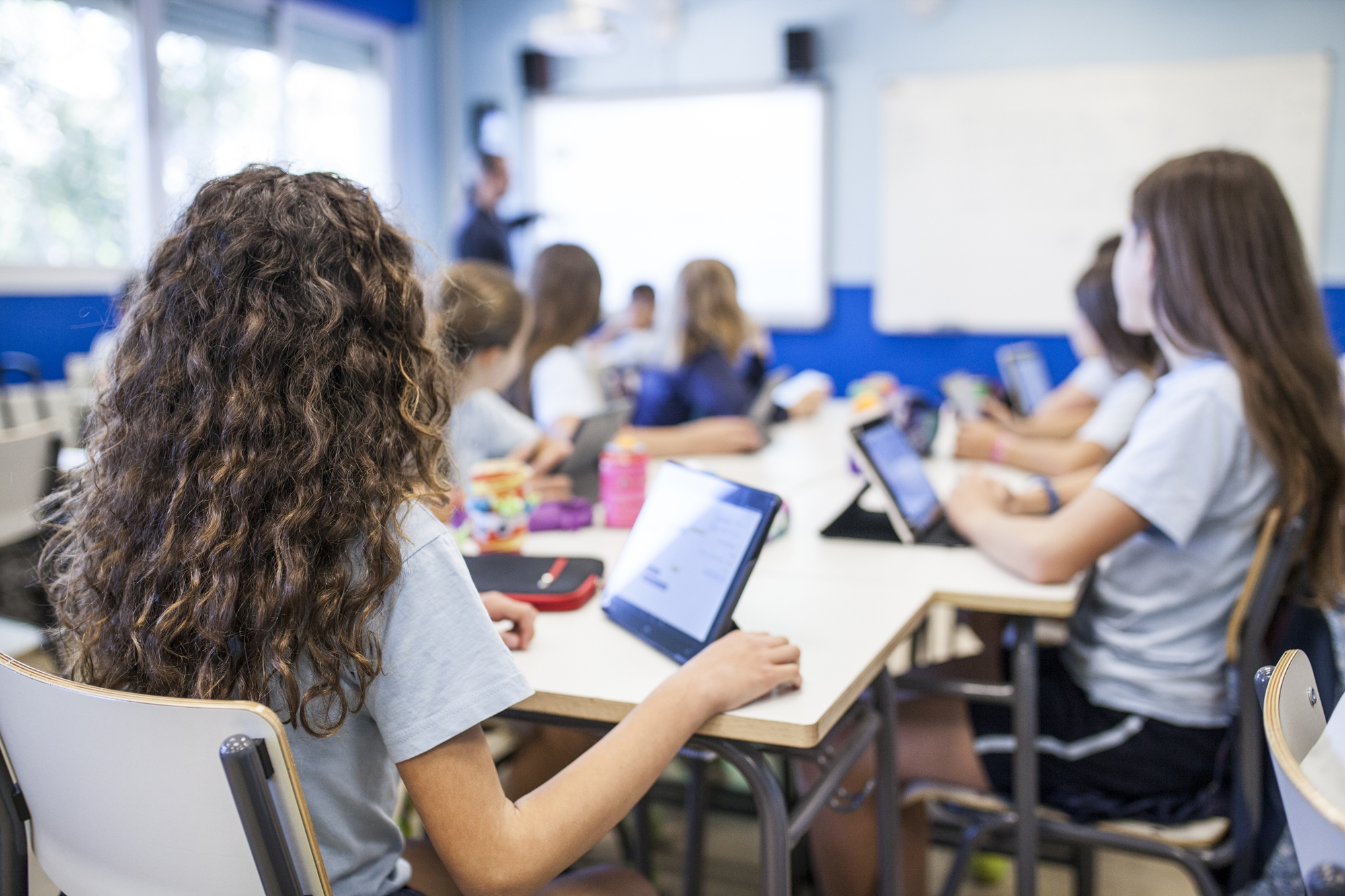 students in class working on tablets